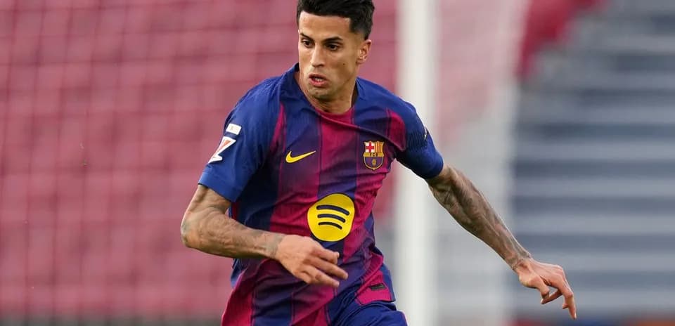 Player in FC Barcelona jersey running on the field