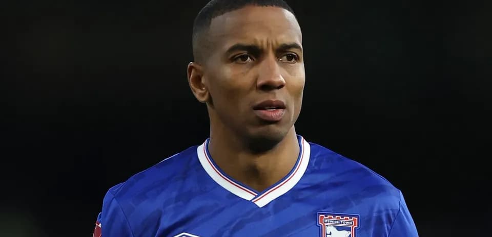 Football player in Ipswich Town jersey on field