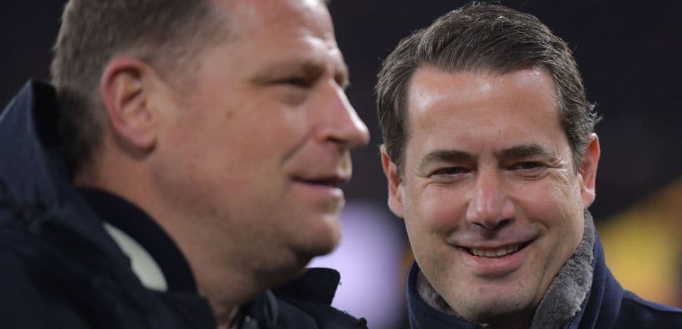 Two men conversing at a sports event