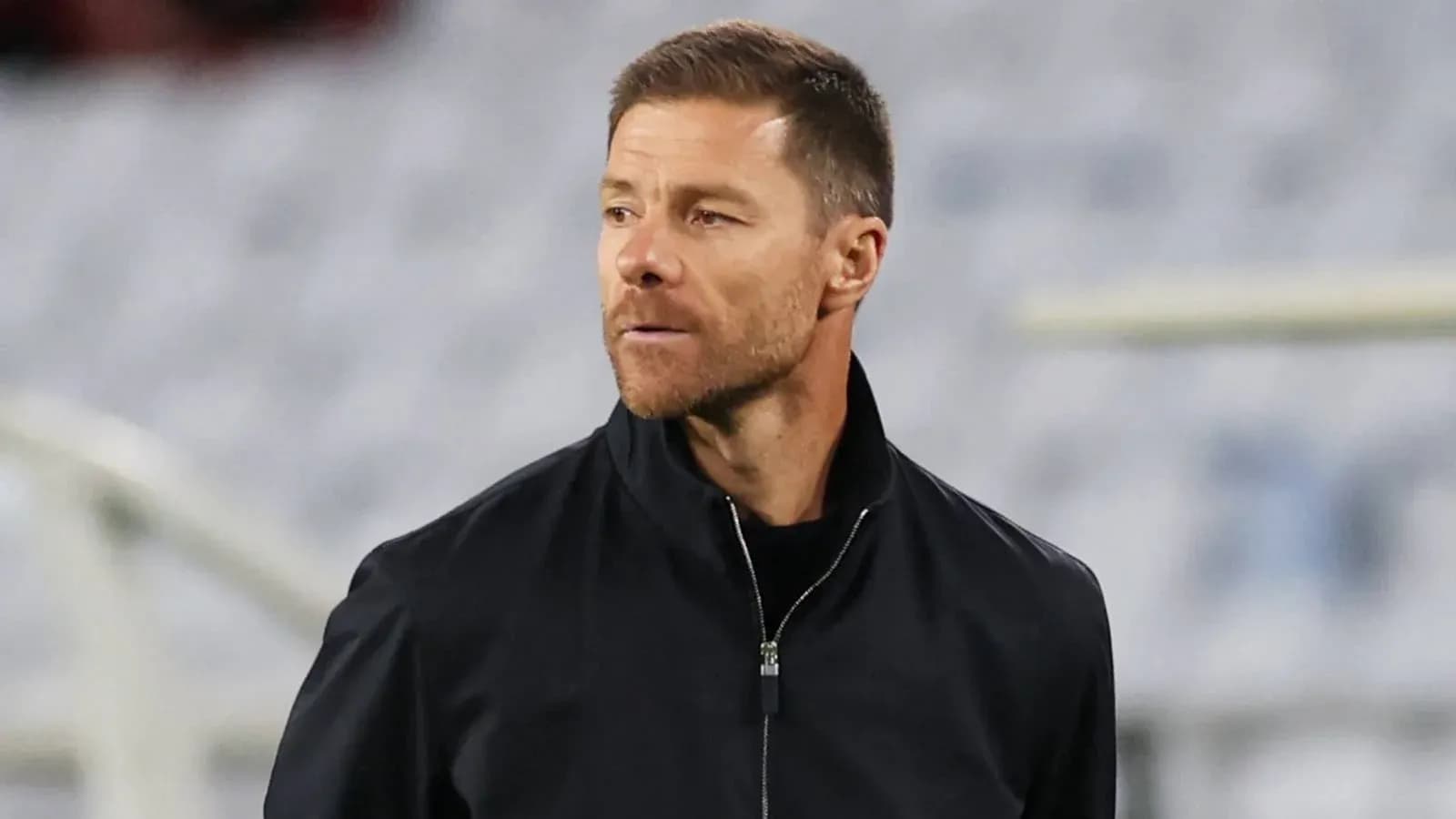 Coach observing during a match on the sidelines