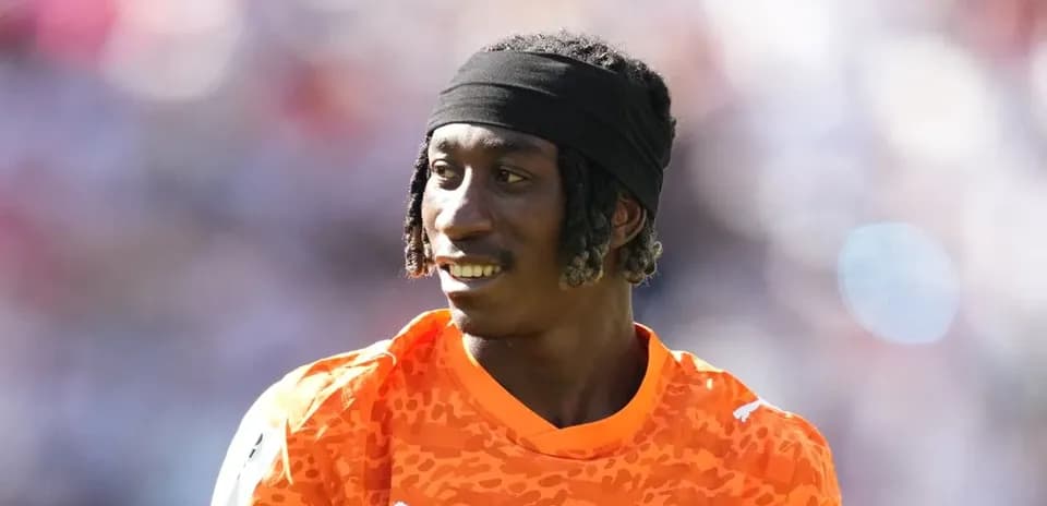 Goalkeeper wearing orange jersey during match