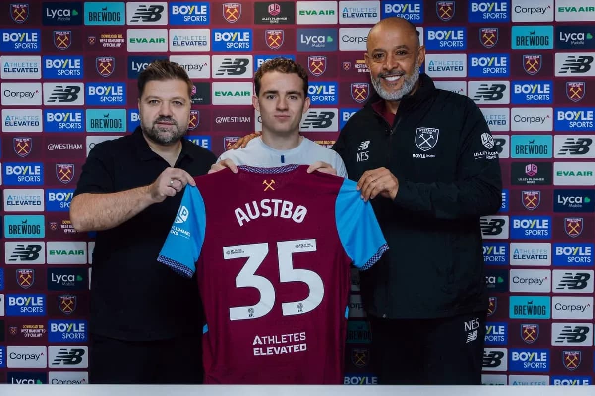 Player holding jersey with 'AUSTBØ' during signing ceremony