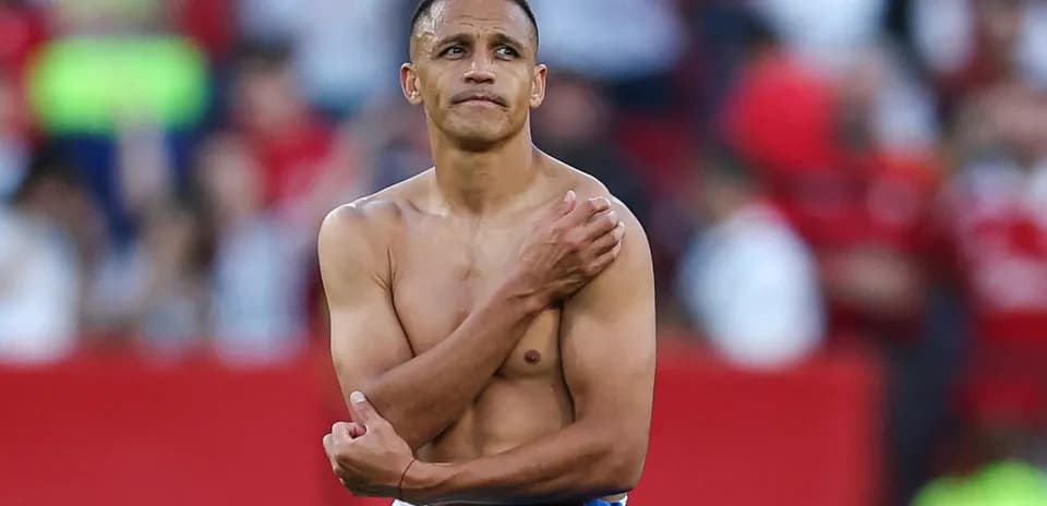 Player with shirt off on the pitch post-match