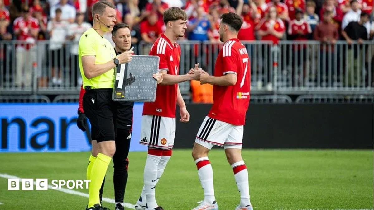 Players shaking hands during substitution in match