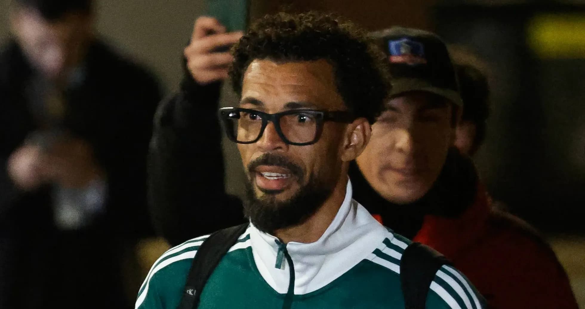 Player arriving at event wearing green tracksuit