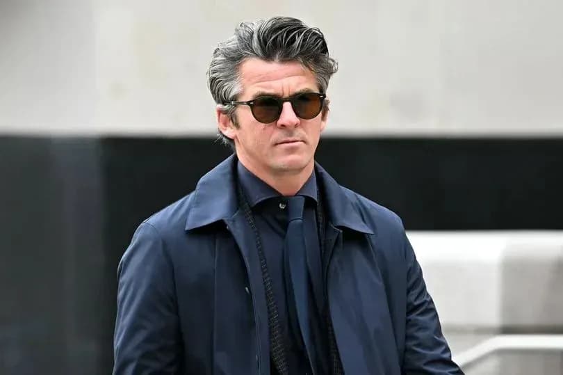 Man in sunglasses walking outdoors in stylish attire