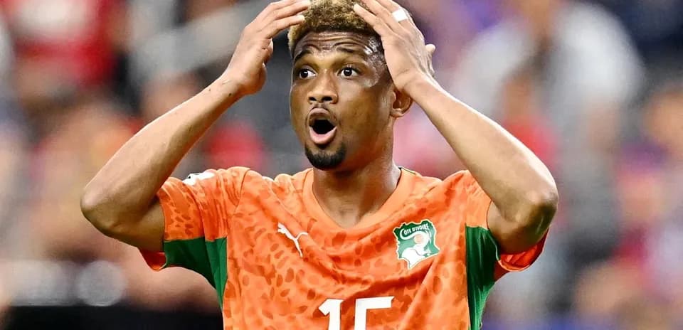 Player in orange jersey reacting during the match