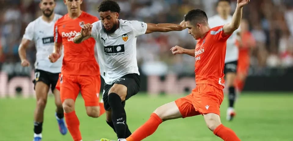 Real Sociedad players contesting a ball against Valencia