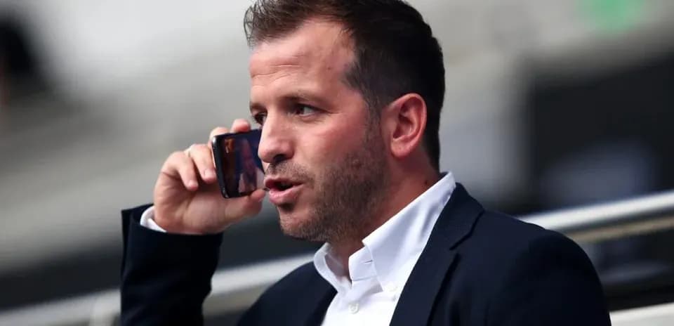Man speaking on the phone in stadium seats