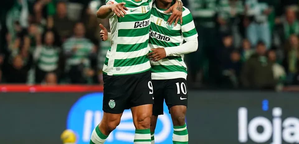 Two players celebrating on the field after a goal