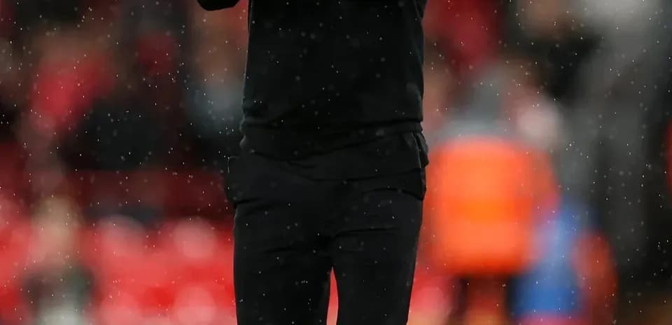 Coach applauding on the sidelines during match