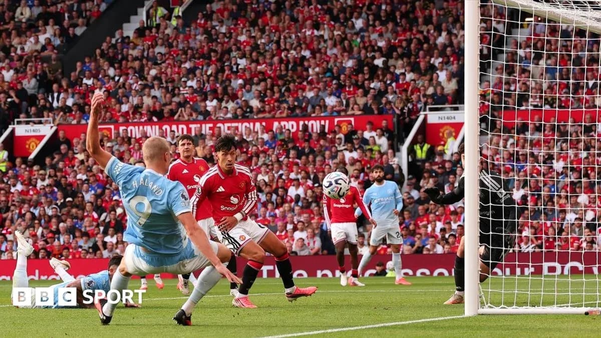 Player striking the ball during Manchester derby match