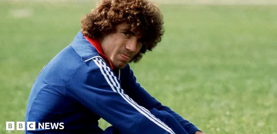 Player sitting on grass field in training attire