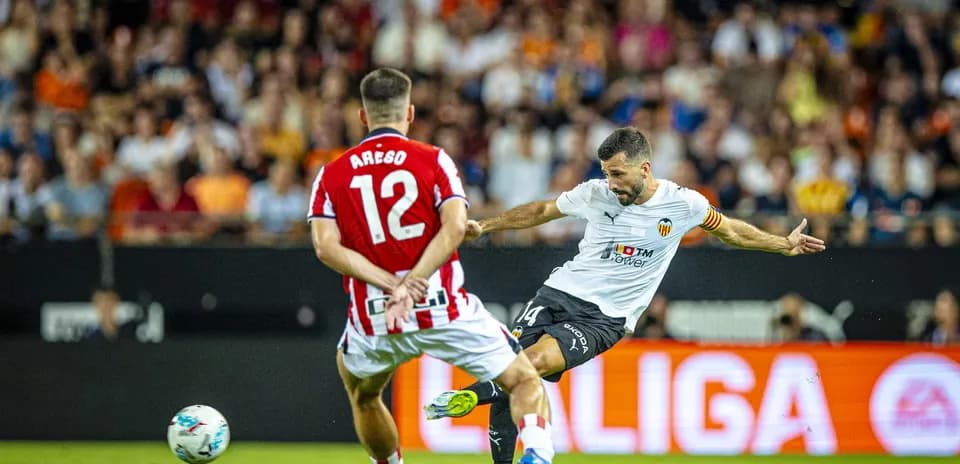 Valencia player shoots during La Liga match