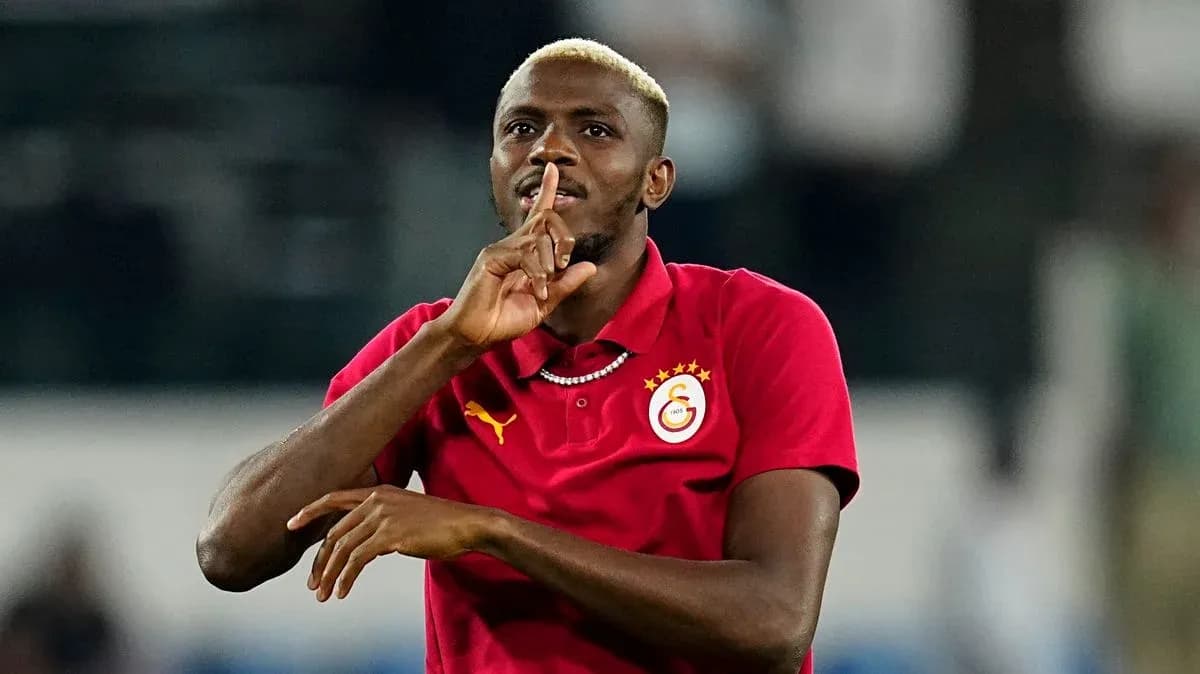 Player gesturing with finger to lips in celebration