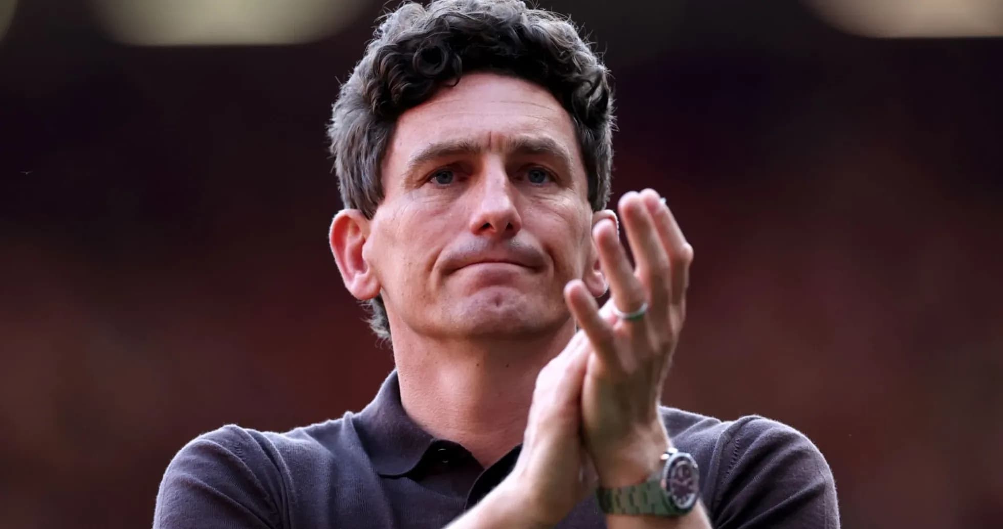 Man applauding in a sports setting