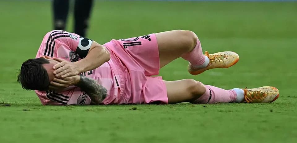 Player lying on the field in pink uniform