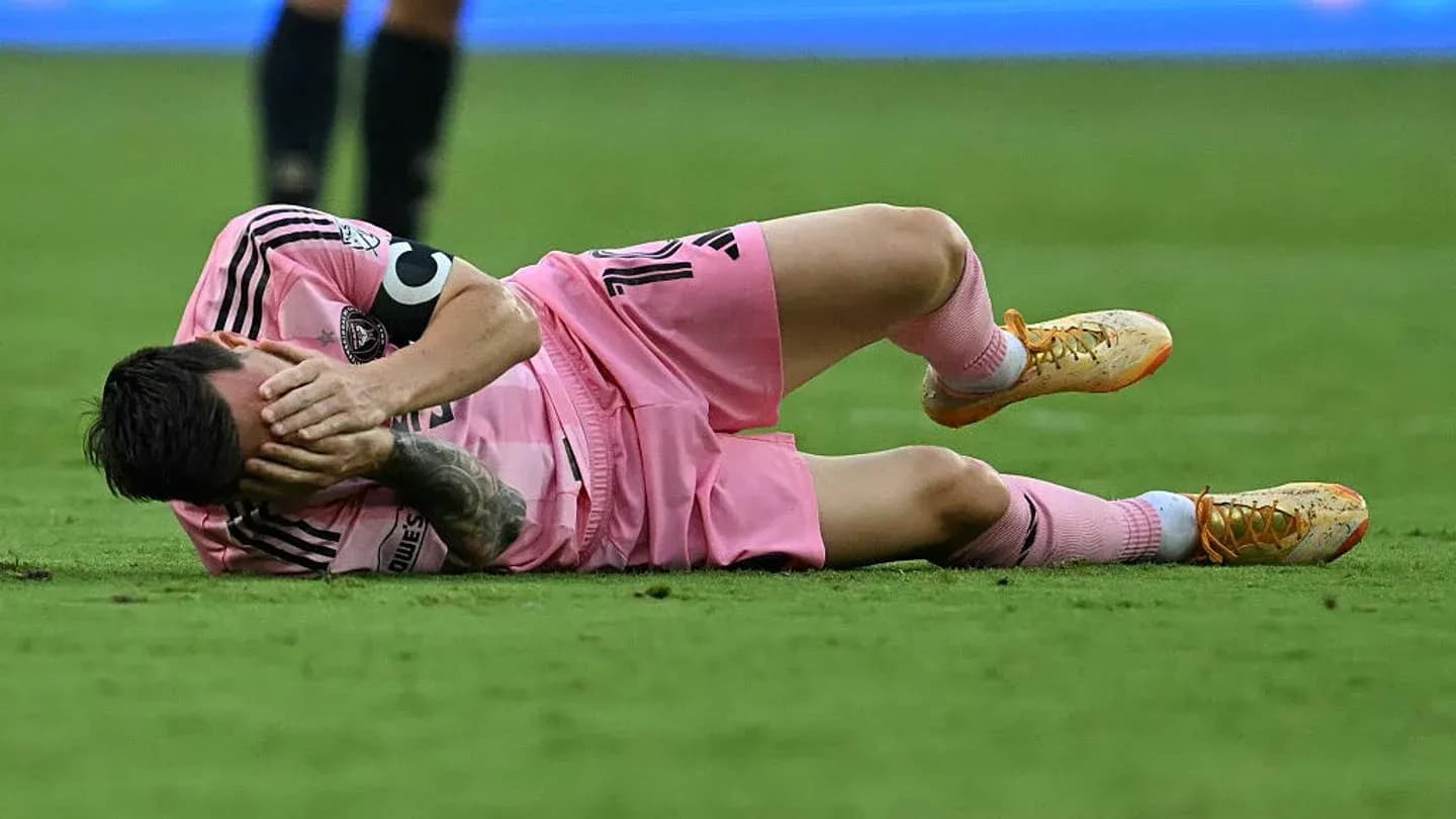 Player lying on the field in pink uniform Player lying on the field in pink uniform