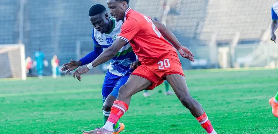 Two players contesting for the ball on field