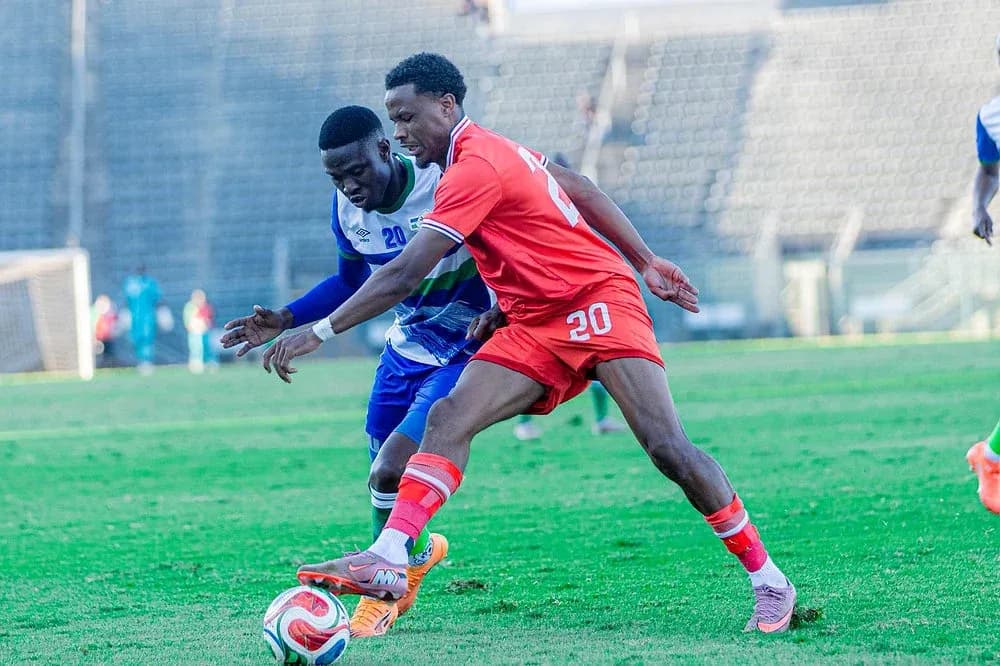 Two players contesting for the ball on field