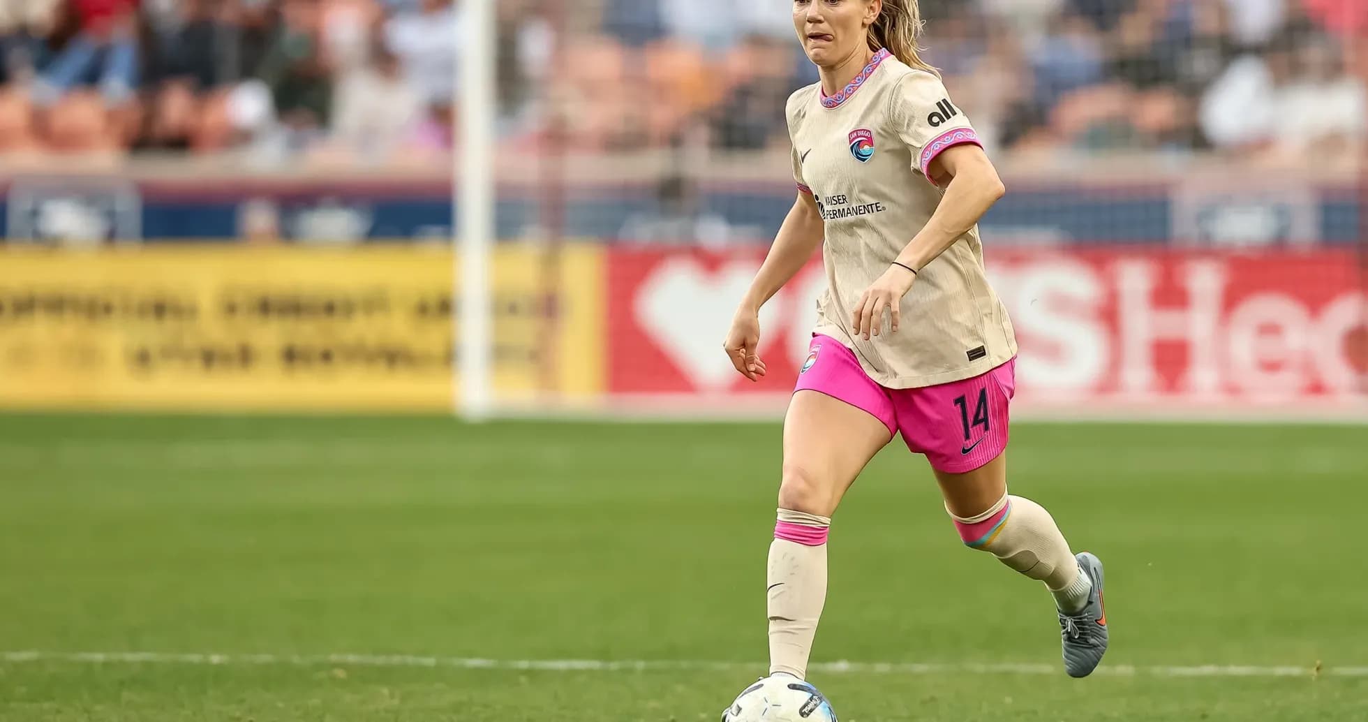 Houston Dash player dribbling the ball on field