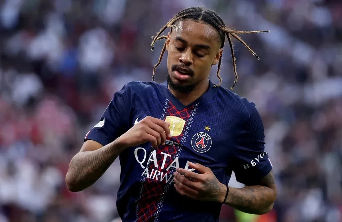 Player adjusting badge on PSG jersey during match