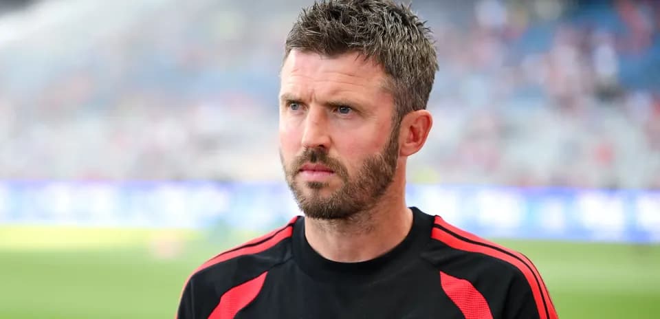 Coach in Manchester United training gear on field