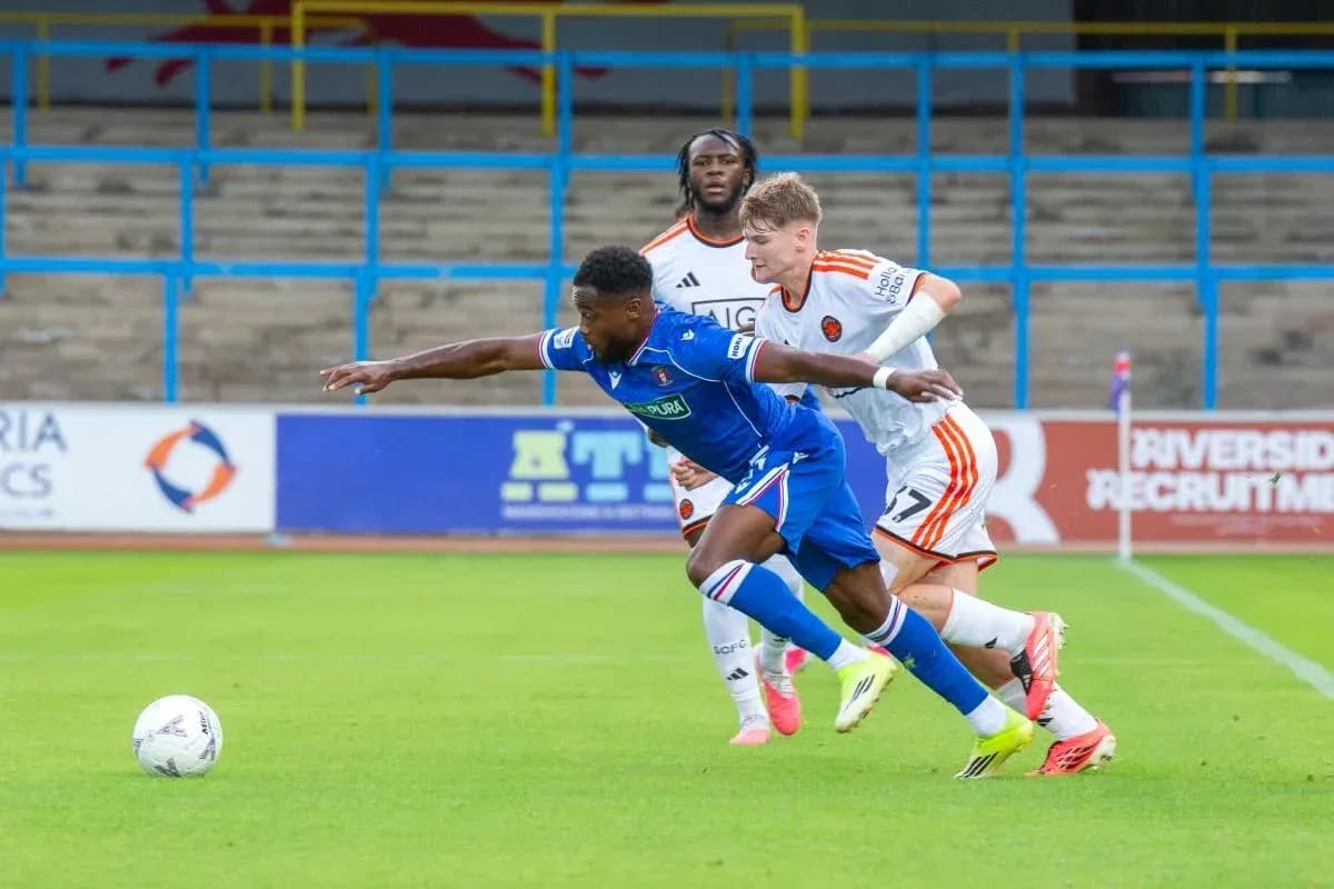 Player dribbling the ball with defenders pursuing