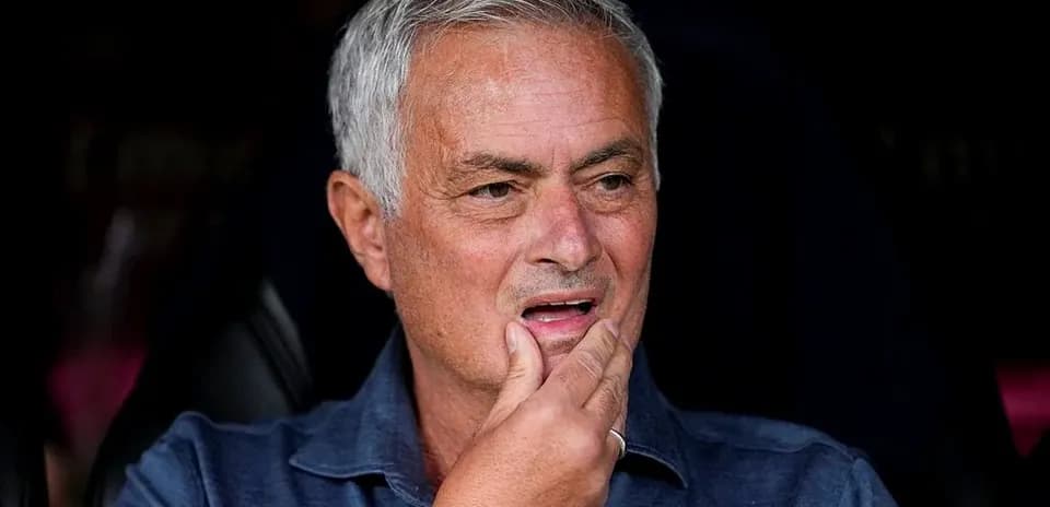 Manager sitting on bench during match