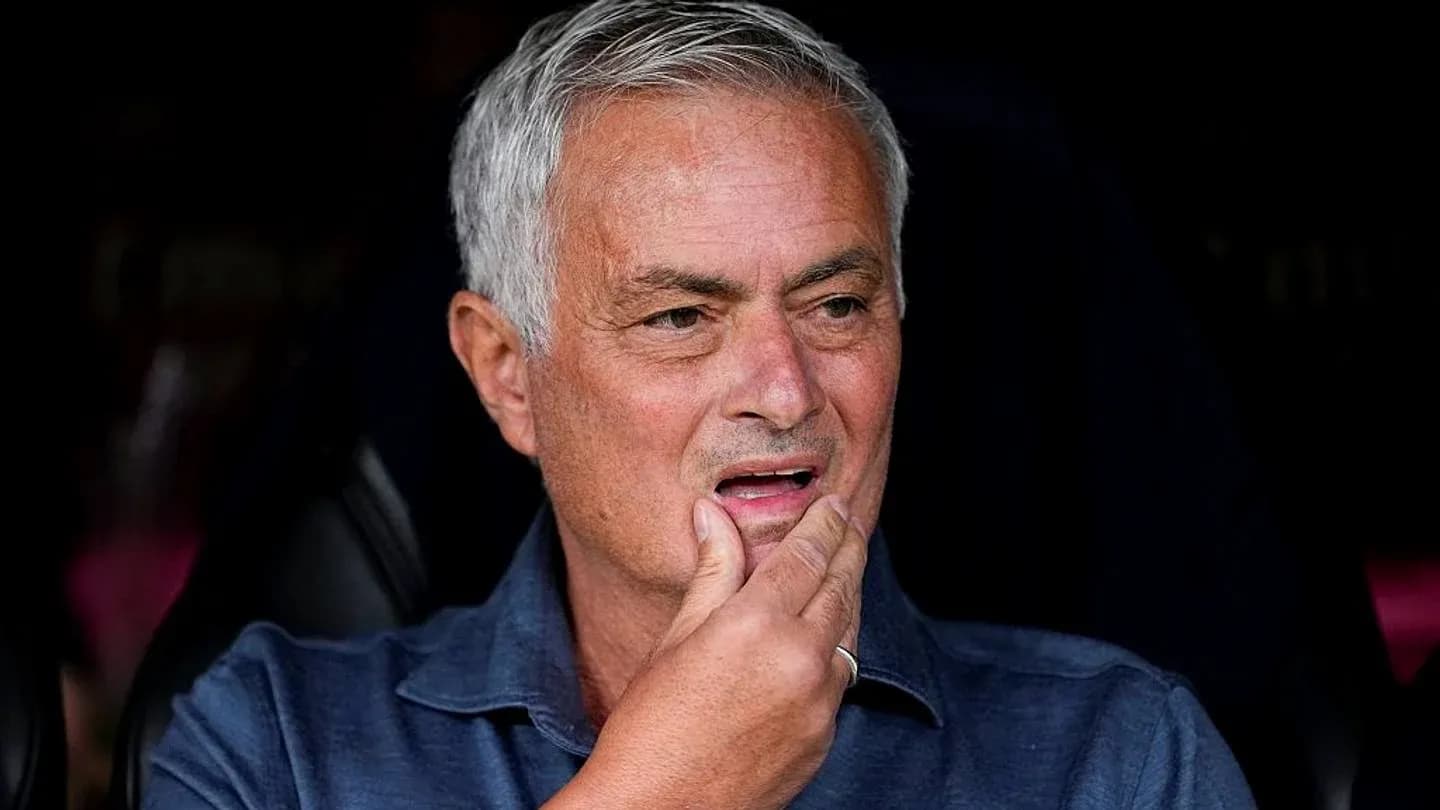 Manager sitting on bench during match