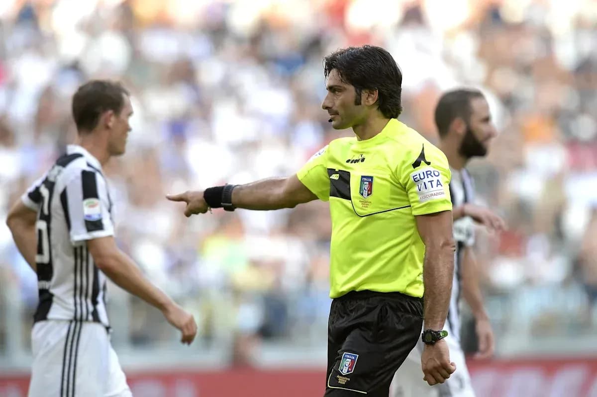 Referee signaling to Juventus players during match