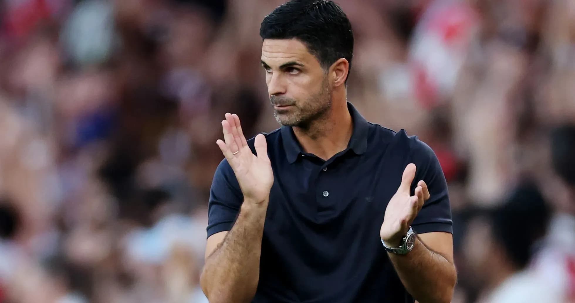 Coach clapping during a match on the sidelines