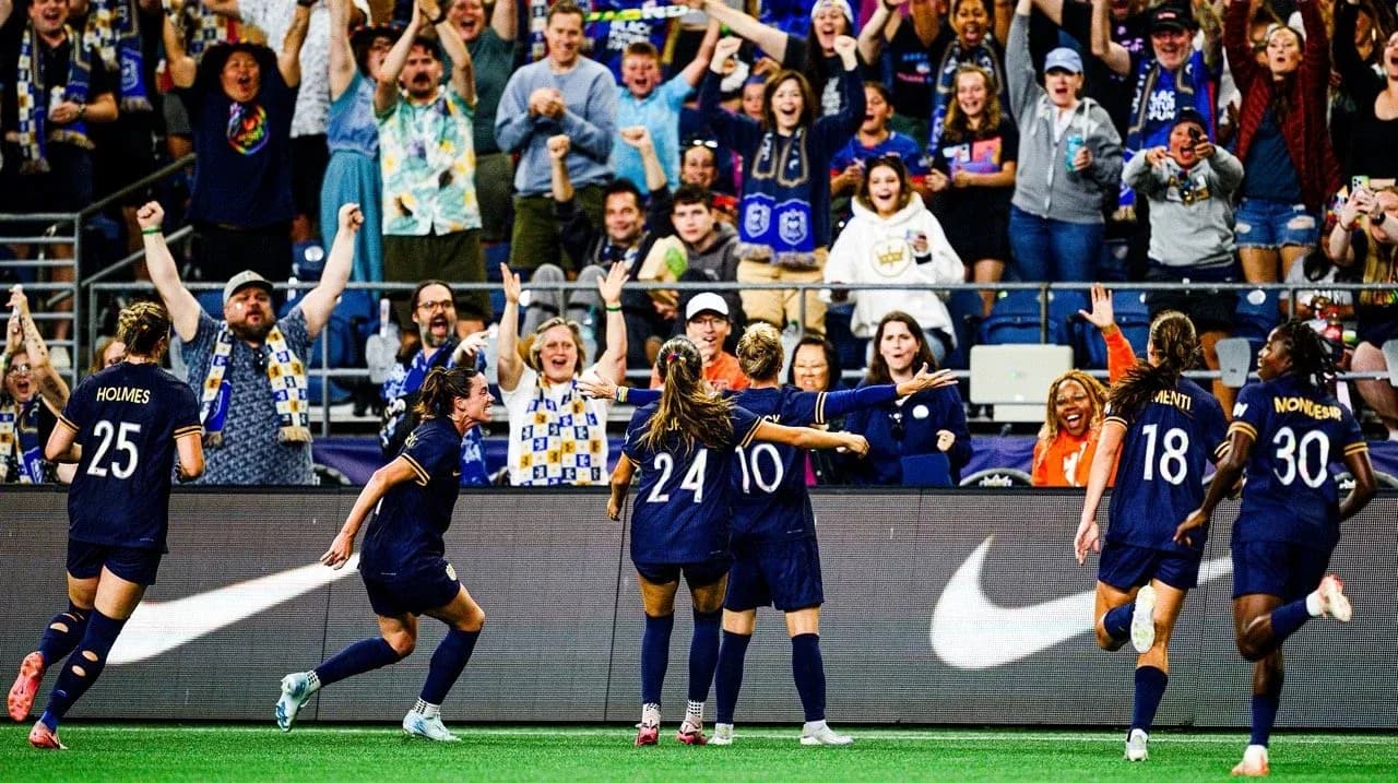 Seattle Reign FC celebrating a goal with fans