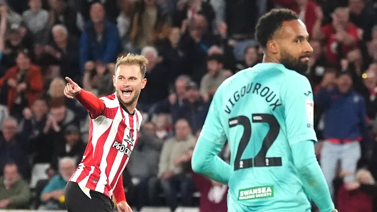 Player celebrating a goal with fans in background