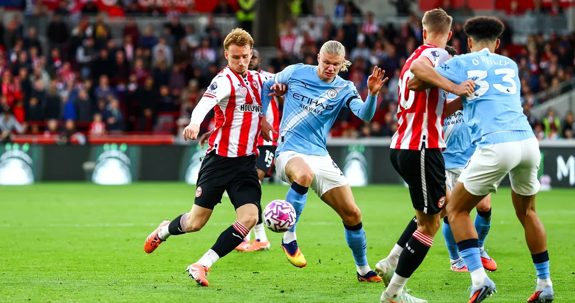 Erling Haaland challenged by Brentford player