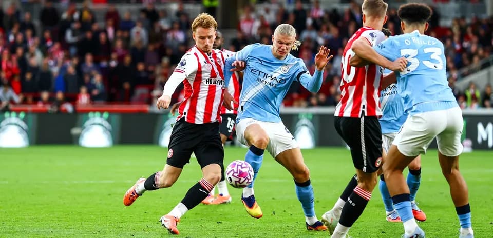 Erling Haaland challenged by Brentford player
