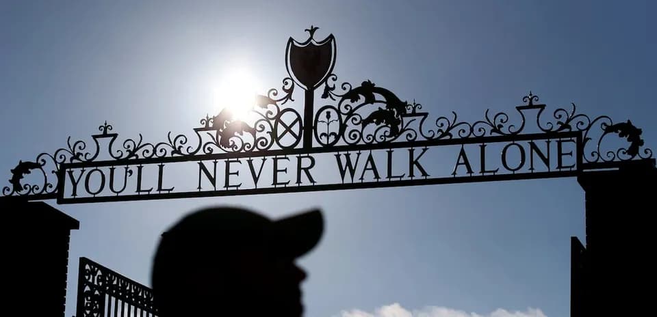 Sign saying 'You'll Never Walk Alone' with silhouette