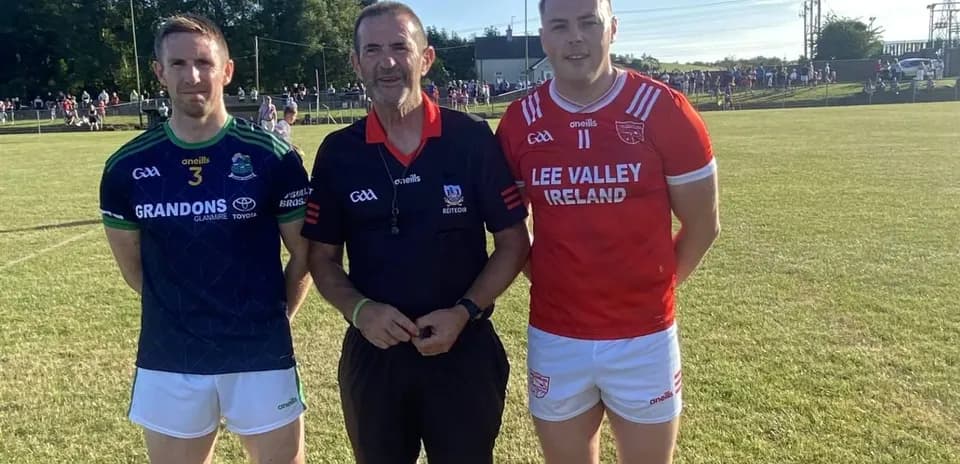 Two players and referee posing before the match
