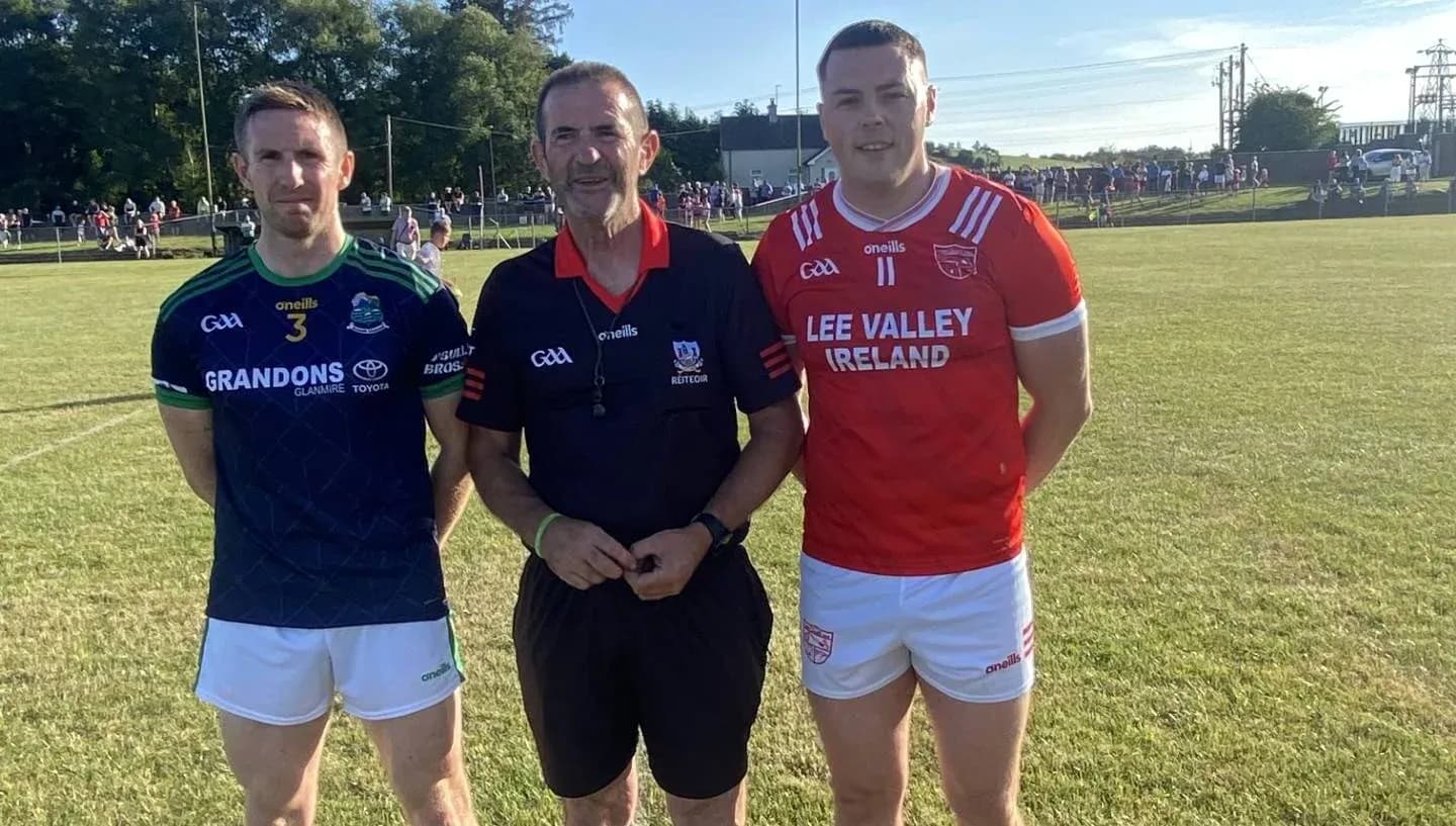 Two players and referee posing before the match
