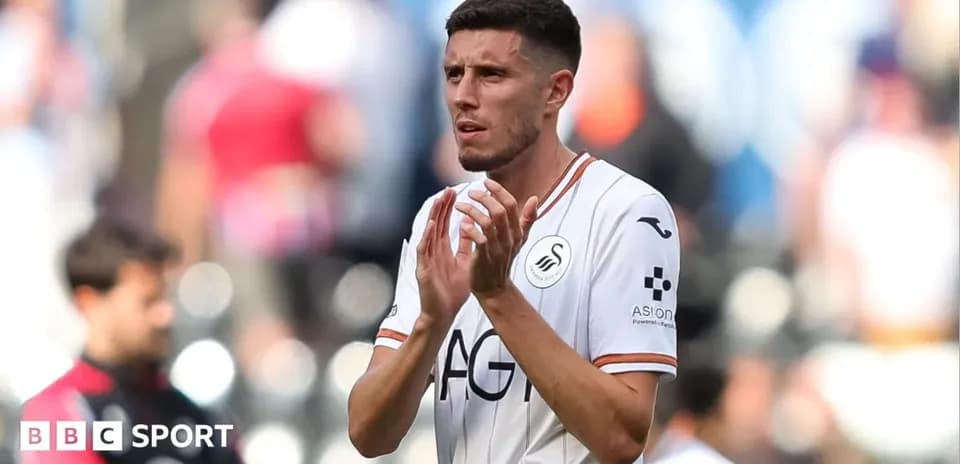 Swansea City player applauding fans after match