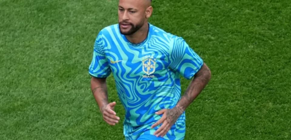 Neymar running on the field in Brazil kit