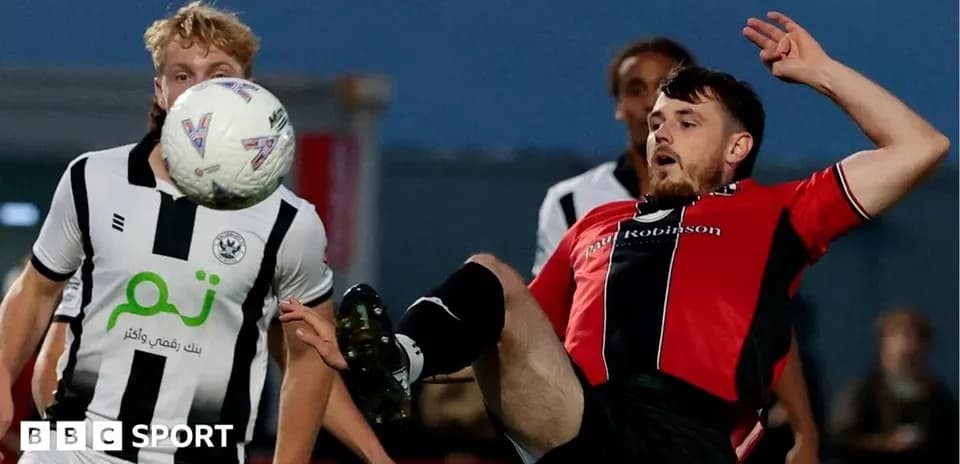 Player kicking the ball during a football match