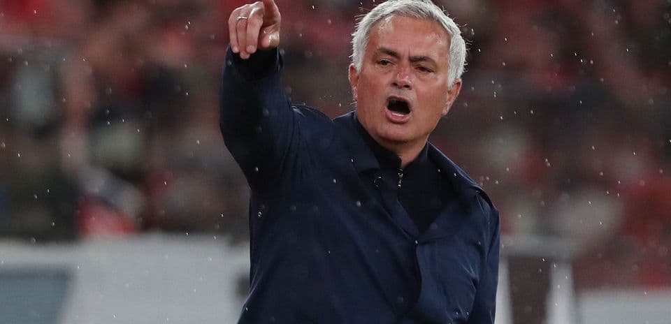 Manager directing players during a rainy match