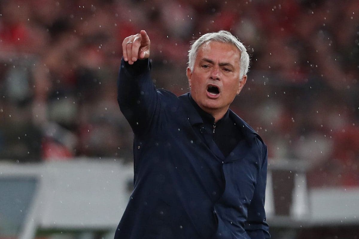Manager directing players during a rainy match
