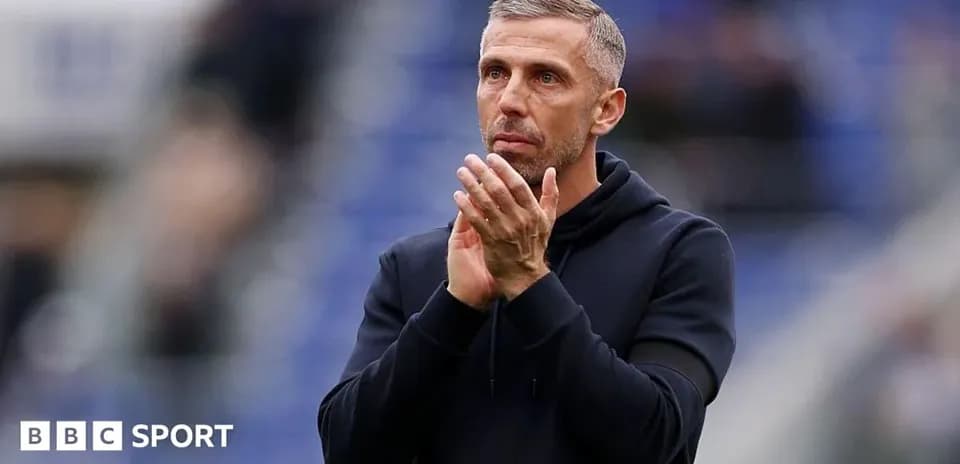 Coach applauding during match at stadium