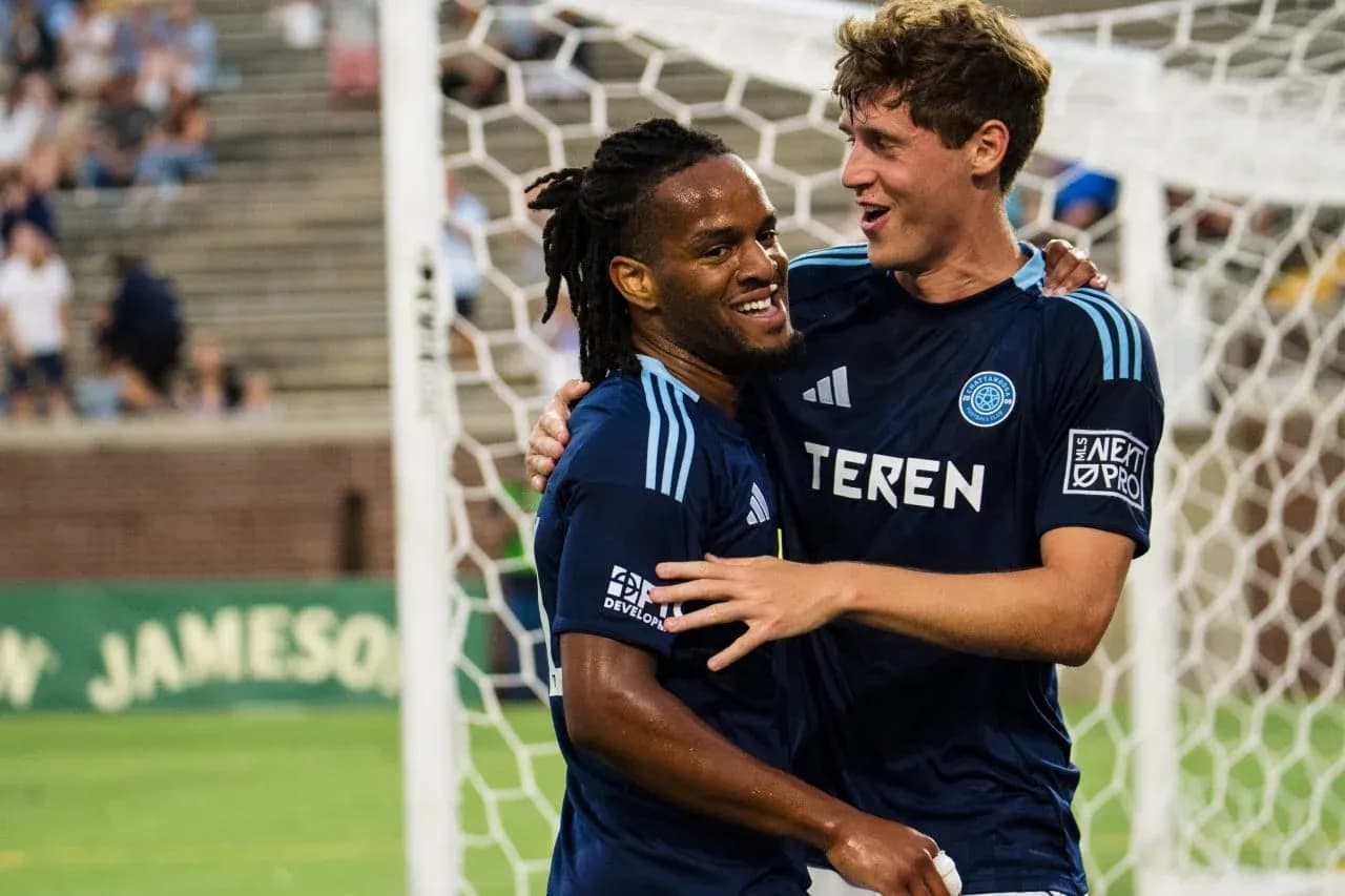Players celebrating after a goal during match