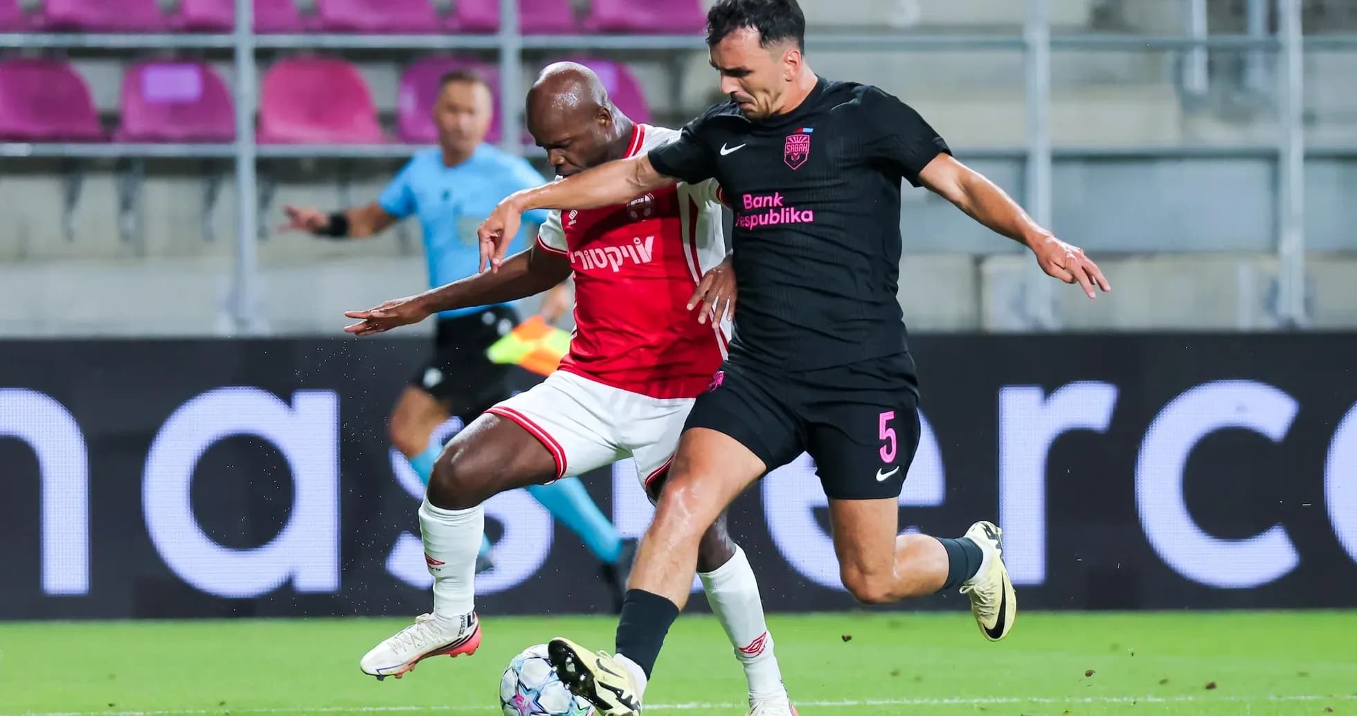 Two players competing for the ball during match