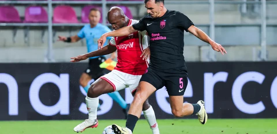 Two players competing for the ball during match