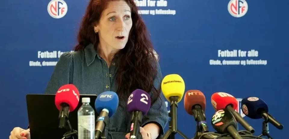 Official speaking at press conference with microphones