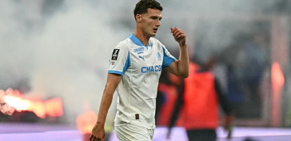 Player walking off the pitch during match with smoke
